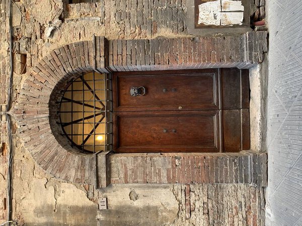 Old door in shabby brick house
