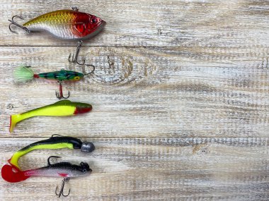 Balık oltası. Tahta bir arka planda süzülür, sallanır, oltaya yem takılır. Seçici odak