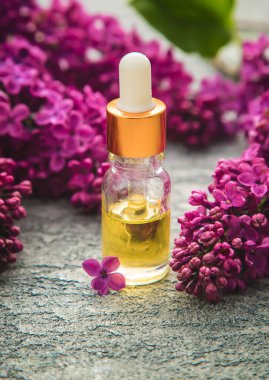 Küçük bir şişedeki leylak yağı. Seçici odaklanma. Doğa.