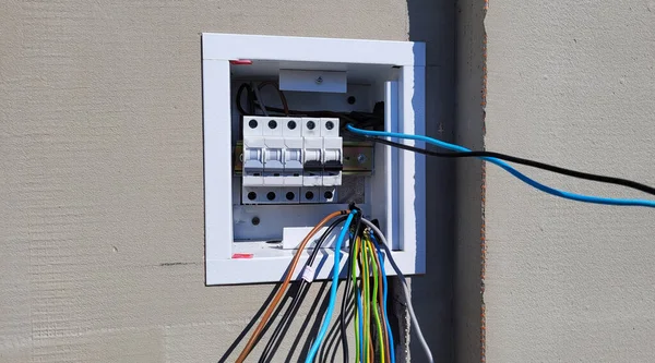 electricity distribution box with wires and circuit breakers (fuse box)