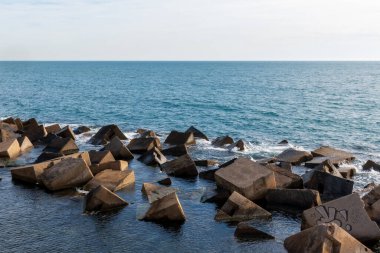 Yapay kayalar bir dalgakıran oluşturuyor. Akdeniz, güneşli bir kış günü