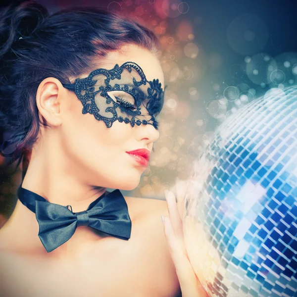 Young sexy woman in carnival mask keeping disco ball — Stock Photo, Image