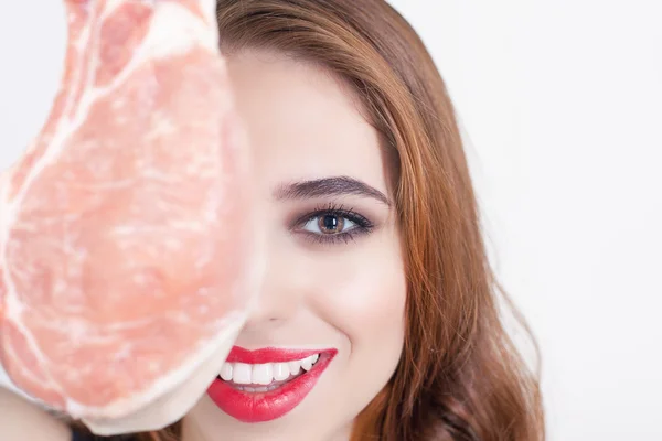 Woman holding packaged meat at the supermarket — Stock Photo, Image