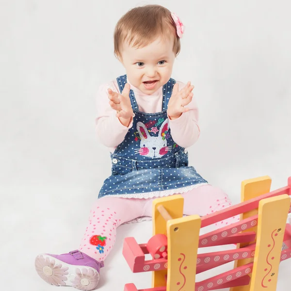 Surprised baby girl playing with toy game for development — Stock Photo, Image