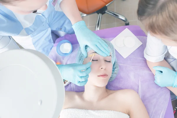 Hermosa mujer en el salón de spa recibiendo depilación o corrección de cejas — Foto de Stock