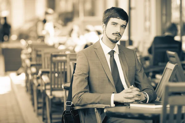 Businessman reading a newspaper at cafe, mourning — Stock Photo, Image