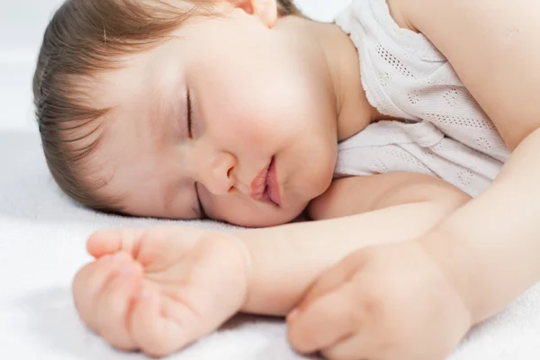 Newborn baby sweet sleeping on a white bed — Stock Photo, Image