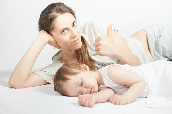 Newborn baby sweet sleeping on a white bed — Stock Photo, Image