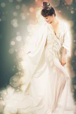 Beauty fashion model dressed in white carnival dress for party