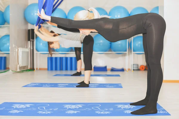 Young women doing aerial yoga exercise or antigravity yoga — Stock Photo, Image