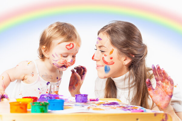 Mom and baby draws with colored inks paint