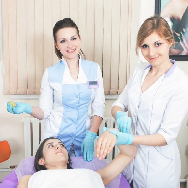 Hermosa mujer en el salón de spa recibiendo depilación o corrección e — Foto de Stock