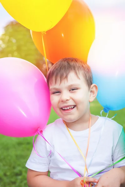 Happy child with balloons outdoor — Stock Photo, Image