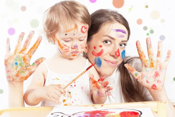 Mom and baby draws with colored inks paint Royalty Free Stock Photos