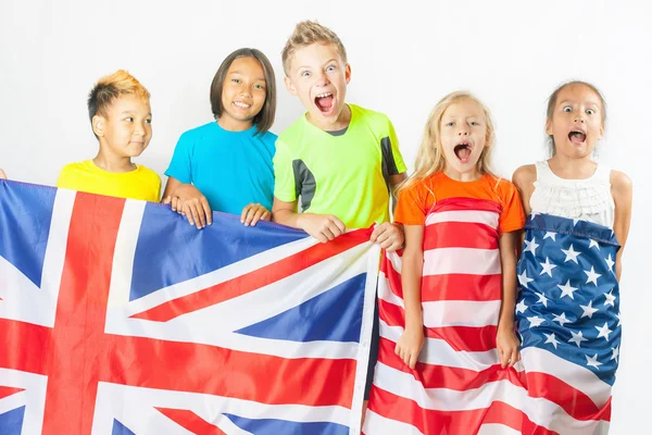 Funny kids holding flag Great Britain and american national flag