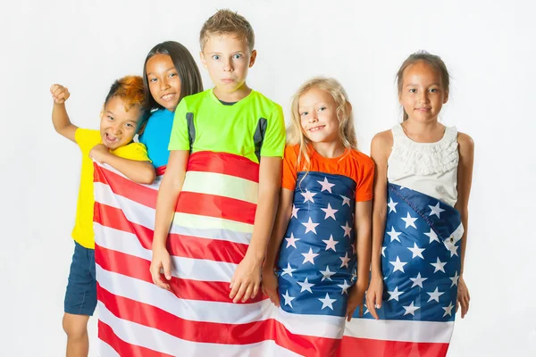 Group of school children holding american national flag Royalty Free Stock Images