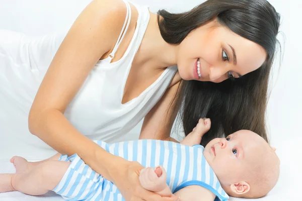 Happy mother holding a baby boy at white background — Stock Photo, Image