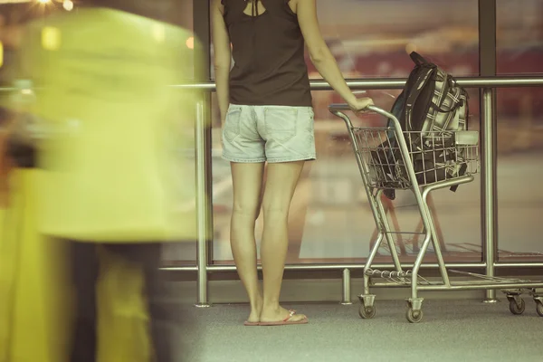 Teenager with trolley in airport — Stock Photo, Image