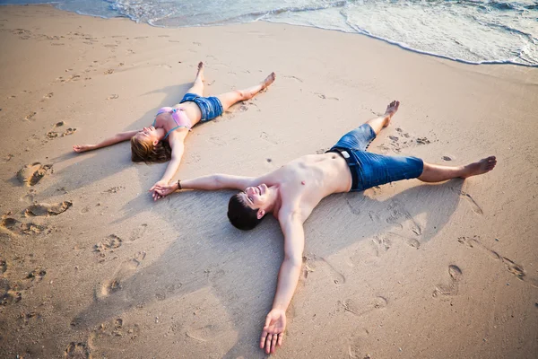 Couple lying on the beach Stock Image