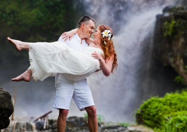happy couple near waterfall clipart