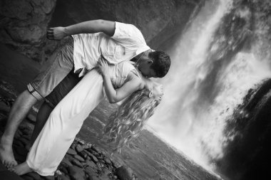 couple travel near the waterfall clipart