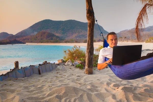 man uses laptop remotely