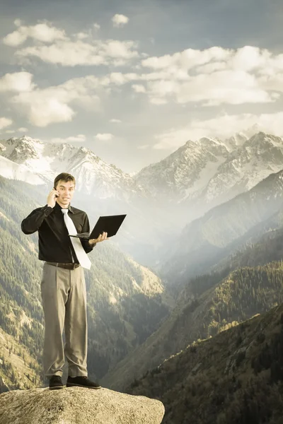 Businessman using mobile phone and laptop — Stock Photo, Image