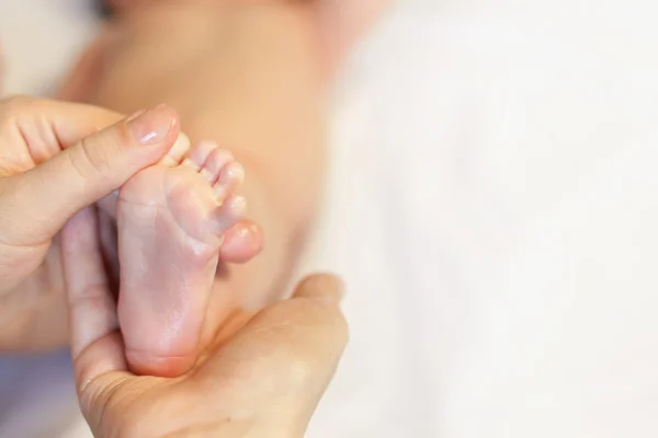 Mother makes massage for happy baby — Stock Photo, Image