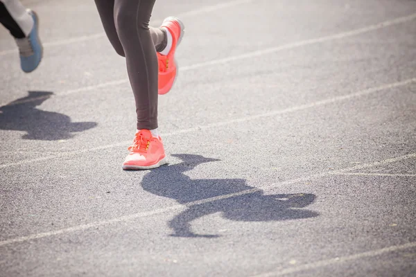 Marathon of womens feet jogging outdoor by the road — Stockfoto