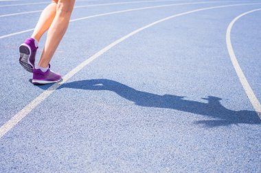 sprint of womens feet jogging outdoor by the road