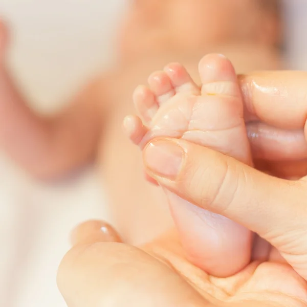 Mother makes massage for newborn baby — Stok fotoğraf