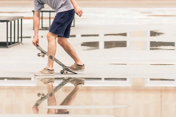 Skateboarder riding a skateboard on the street or park — Stok fotoğraf