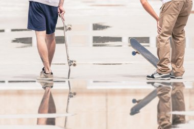 handsome guys with skateboard at freestyle park outdoors