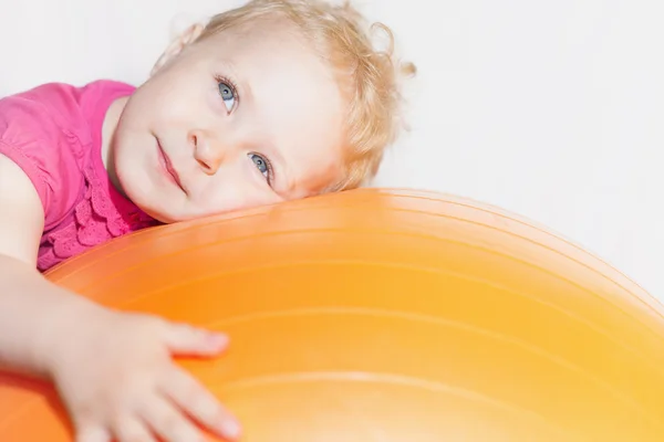 Happy child doing exercises at gymnastic ball — ストック写真