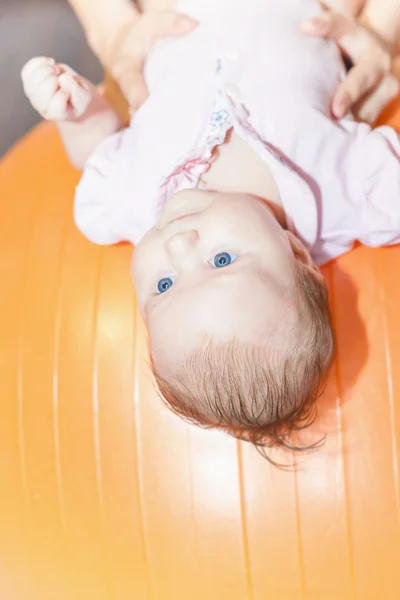 Mom with happy baby doing exercises at gymnastic ball — Stock Photo, Image