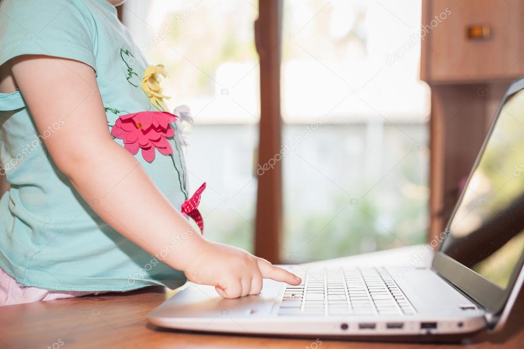 Child using laptop at home