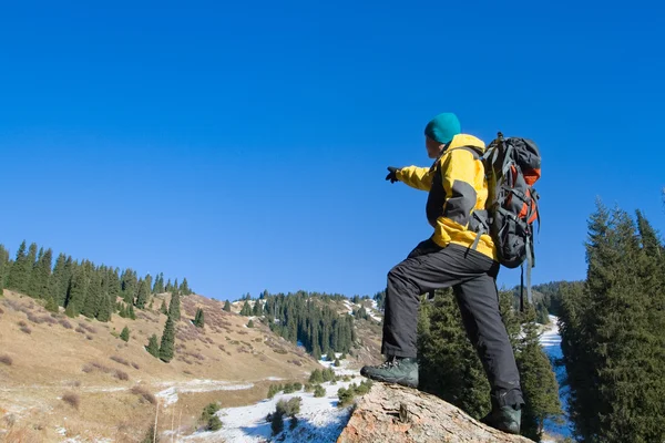 Climbing young adult at the top of summit