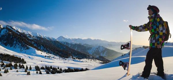 Hombre de deporte en las montañas nevadas al atardecer — Foto de Stock