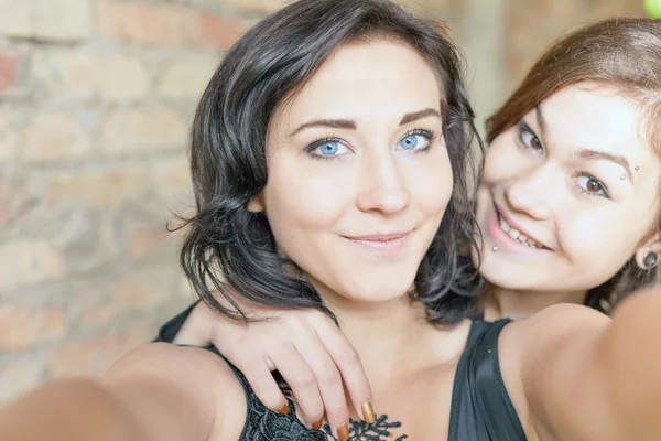 Two happy girls make selfie on camera or mobile phone — Stock Photo, Image