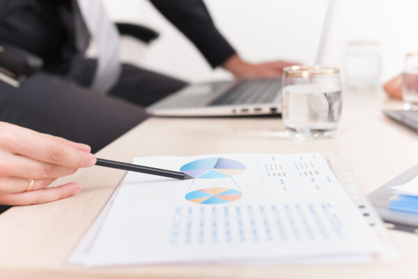 close-up graph and charts on table during business meeting