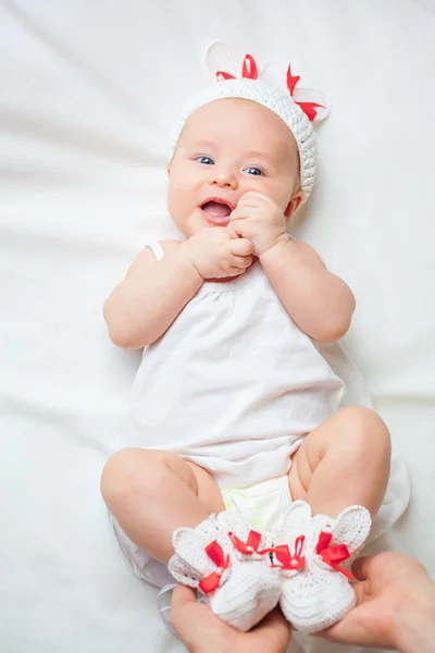 Happy baby girl dressed in knitted bunny costume — Zdjęcie stockowe