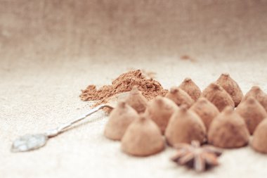 Chocolate truffles candies on a background of burlap bag texture