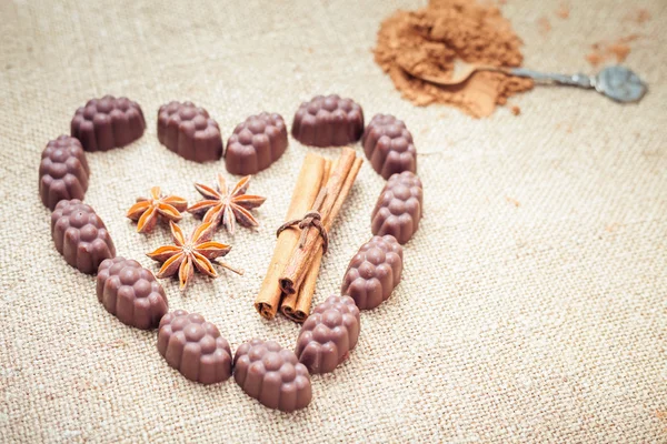 Chocolate candies with liquor in form of heart on background — Stock Photo, Image