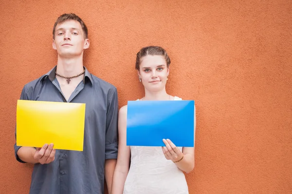 Funny young couple looking at camera and holding frames background Royalty Free Stock Images