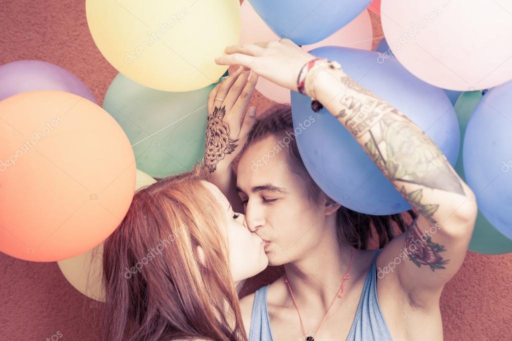 Happy and funny couple kissing at background of color balloons Stock Photo by ©Petunyia 80722562 Happy and funny couple kissing at background of color balloons Stock Photo by ©Petunyia 80722562