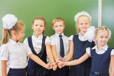 Successful group of children at school with thumb up gesture 