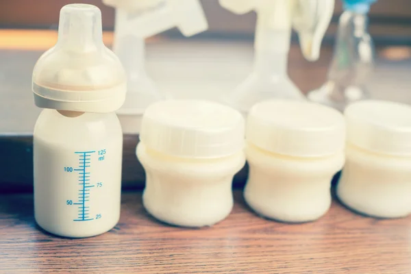 Manual breast pump and milk at background — Stock Photo, Image