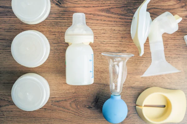 Background of manual, automatic breast pump, baby bottle with milk — Stockfoto