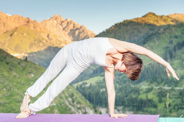 Inspired asian woman doing exercise of yoga at mountain range — Stock Photo, Image