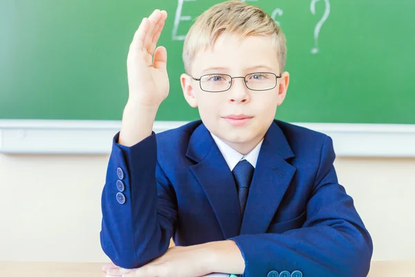 Schoolboy ready to answer and raised hand up — Stock Fotó